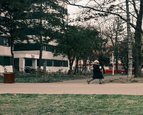 Woman walking happily in a bright park environment